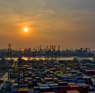 a large amount of containers of containers sit in a harbor