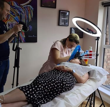 a woman is getting her hair done by a professional photographer