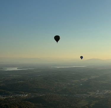 a hot air balloon in the sky with a view of the city