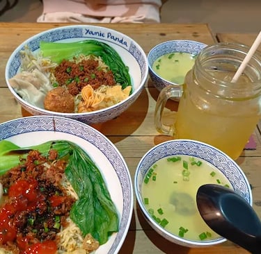 a table with bowls of food and drinks