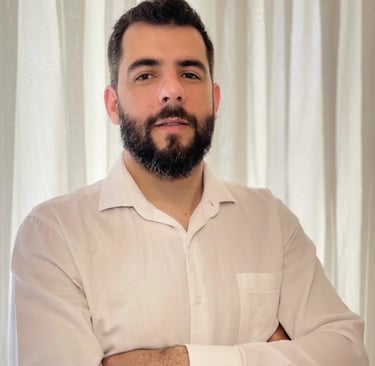 a man with a beard wearing a white shirt