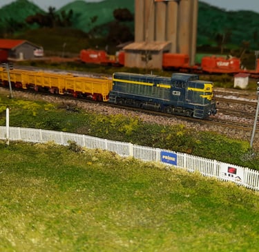 A goods train leaves Widgeree station passing the local AFL ground