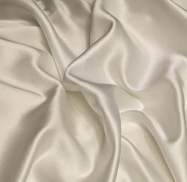 a white satin and silk fabric with a satin finish