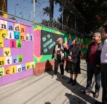 a group of people standing around a fence