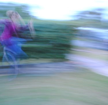 a blurred photo in color of author Dawn Davies leaping in the air