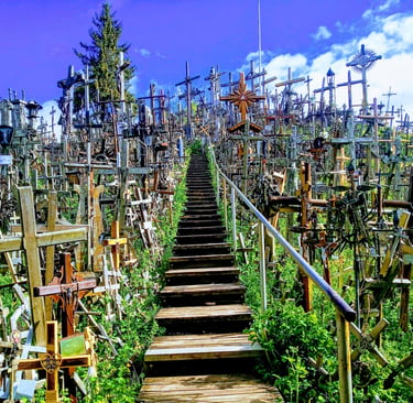 A wooden staircase leads through thousands of crosses at the Hill of Crosses in Lithuania.