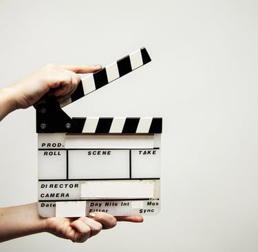 a person out of shot holding a clapper board