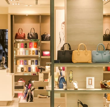 a women's fashion store with handbags and shoes on display