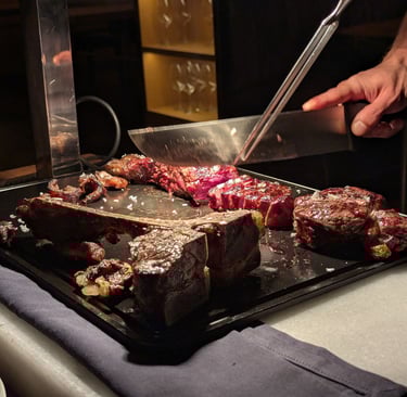 T-bone steak being sliced at the LomoAlto steakhouse in Barcelona