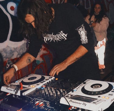 a man in a black shirt is playing a dj -Creechur