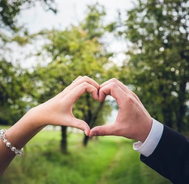 Mains de mariés qui forment un coeur