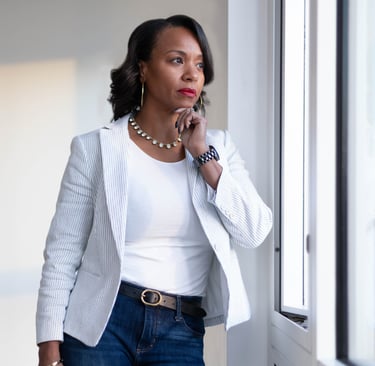 a woman in a white blazer and jeans jeans