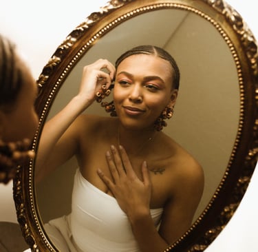 a woman in a white dress is looking at herself in the mirror