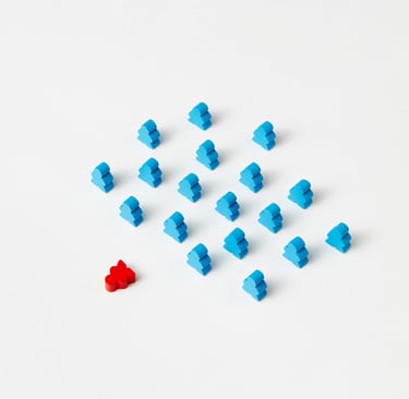 A red figure placed beside a group of blue figures