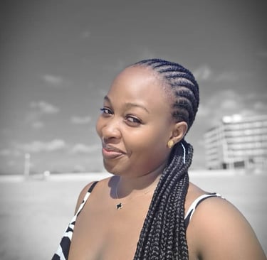A lady with braided hair on a beach