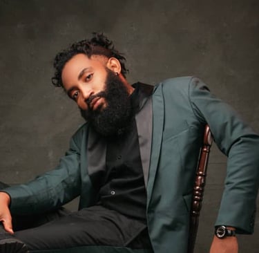 A man wearing a suit while seated on a chair