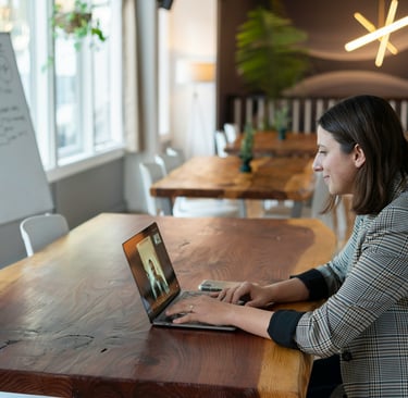 A woman attending a virtual call in an office setting.