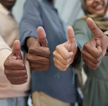 Four hands giving a thumbs up