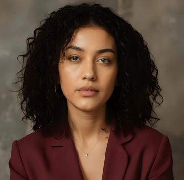 A portrait of a woman with black hair wearing a red blazer.