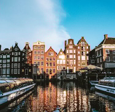 a boat on a river with buildings in the background