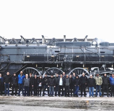 a group of people standing in front of a train