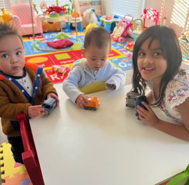 Photo of three young children playing in the daycare.