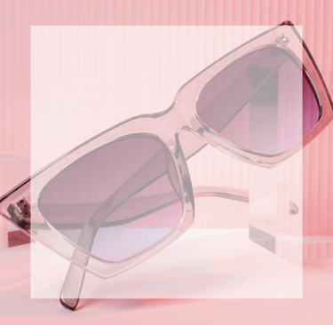 Sunglasses -a pair of pink square sunglasses with a pink background