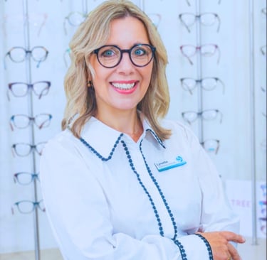Lynette Hunter - Owner and dispensing Optician Smiling woman Blonde shoulder length hair glasses