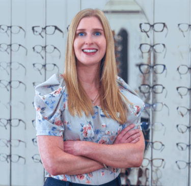 Shonag Laird Optometrist Smiling woman with long strawberry blonde hair and blue eyes