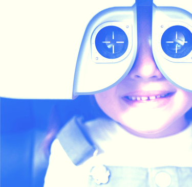 a young girl having eyes test