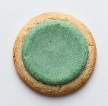 A lively kitchen scene showing hands sprinkling herbs over a sizzling pan of sautéed vegetables.