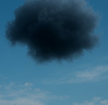 A dark storm cloud in a clear blue sky