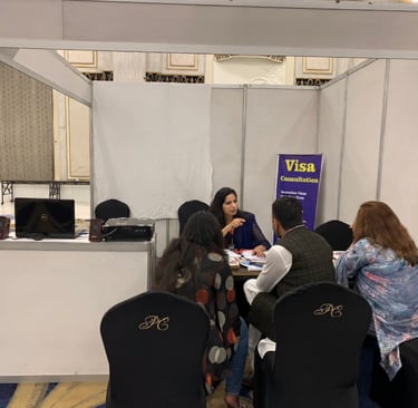 "Immigration consultant advising clients at a visa consultation booth during an event