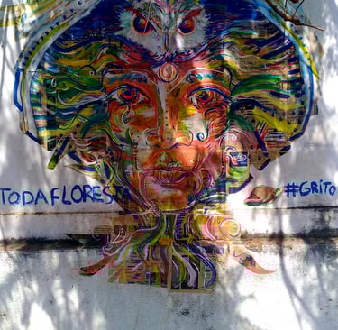 collage d'une peinture aux couleurs vives, où on peut distinguer un visage enraciné, une chouette ou encore une tête de cobra