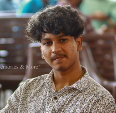 a man with a curly haircut and a flowered shirt