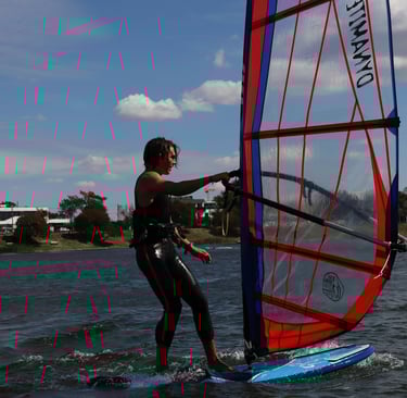 a woman windsurfing on a sunny day