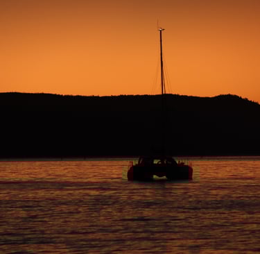 a boat in the water at sunset
