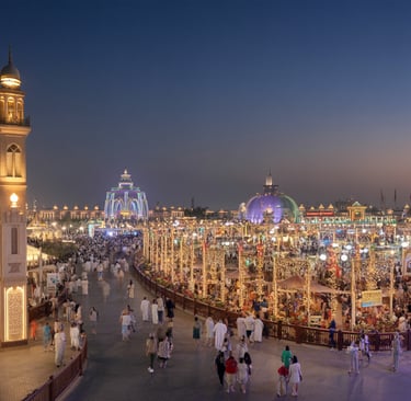 Dubai Global Village at night with colorful lights, cultural pavilions, and crowds of visitors enjoying the festival atmosphe