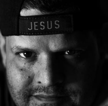 Black & White image of Bryan Avila wearing a hat that says Jesus