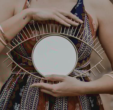 a woman holding a mirror in her hands