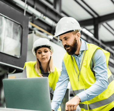 a man and woman in safety vests and hard hats