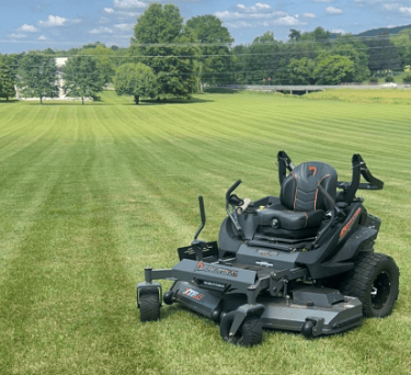 mower at idle with cut grass in background