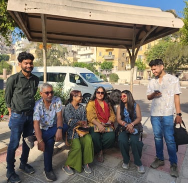 a group of people sitting on a bench in a park
