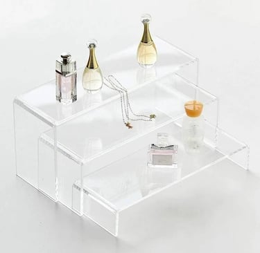 Acrylic risers displaying elegant perfumes and delicate jewelry, enhancing item visibility and decor