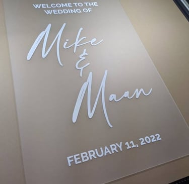 Acrylic wedding welcome sign for Mike and Maan dated February 11, 2022, displayed on a printing bed.