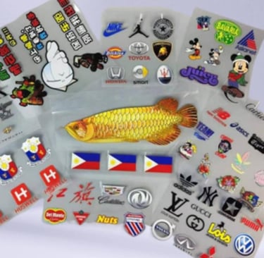Assorted collection of UV DTF printed brand stickers on a transparent sheet.
