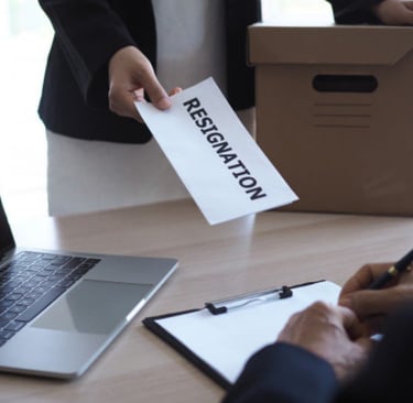 a person holding a piece of paper with a paper sign that says, 'resignation"