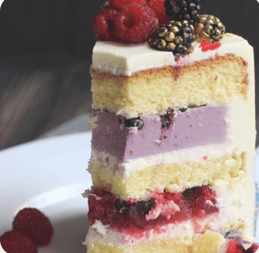a piece of cake with berries on top of it