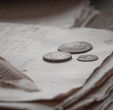 a stack of coins and a pen on a table