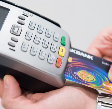 a person holding a credit card and a credit card